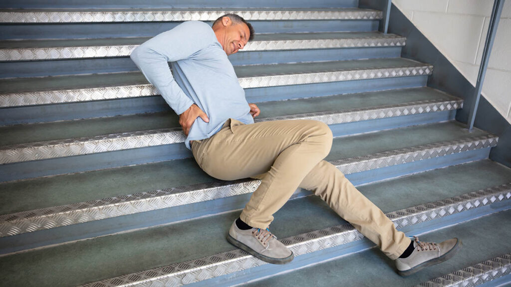 Man laying on ground following a slip and fall accident